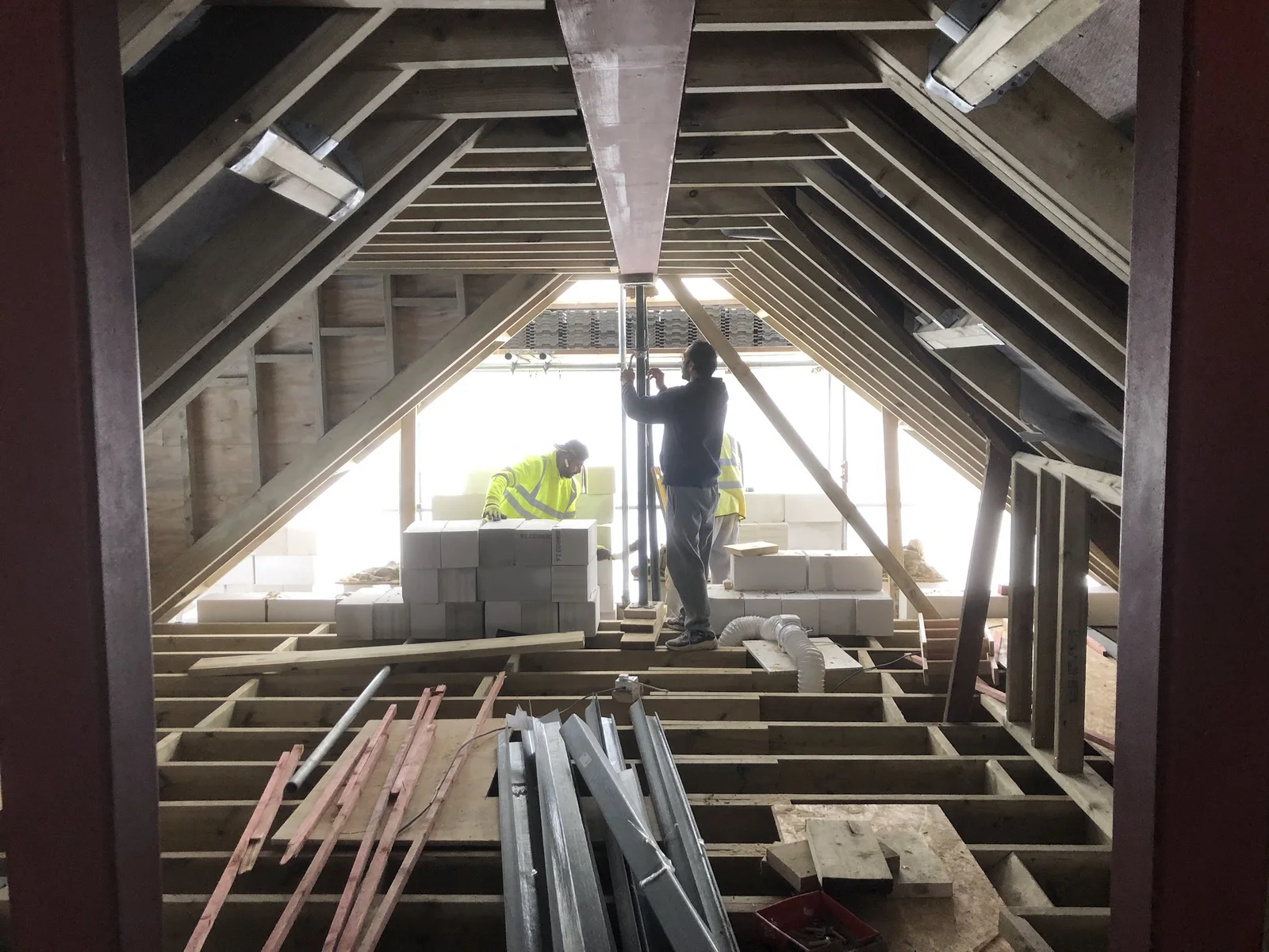 Trident construction specialist working within a dramatic loft structure